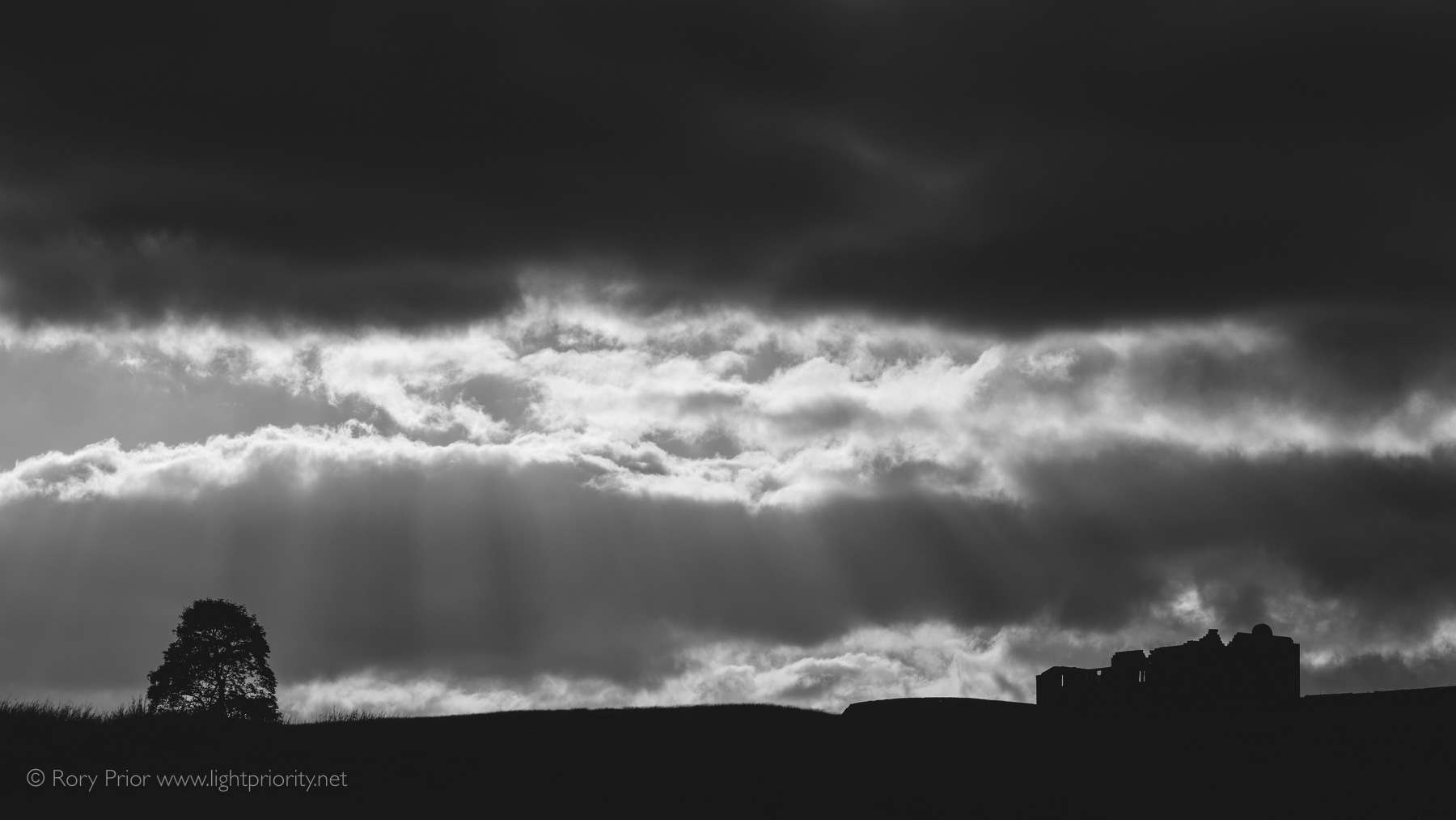 Crepuscular rays in the sky over the ruined Red Dykes farmhouse.